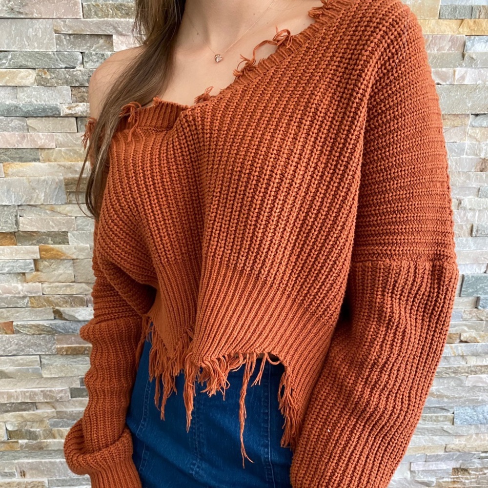 Frayed orange sweater